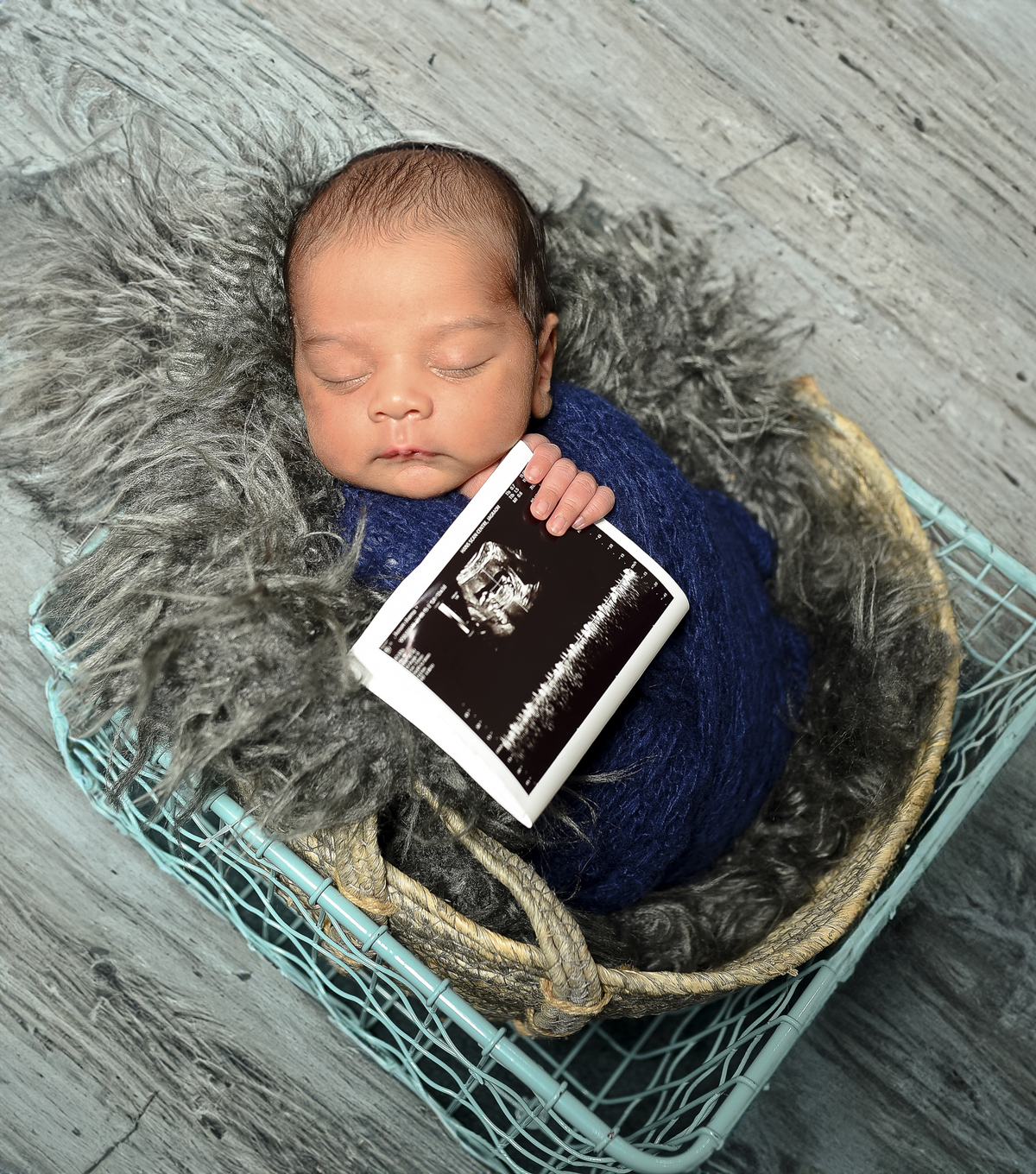 Newborn baby boy posed safely in father’s hands – Burnaby newborn photography studio