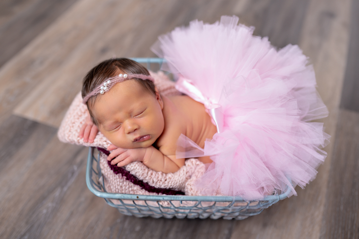 Newborn baby boy posed safely in father’s hands – Burnaby newborn photography studio
