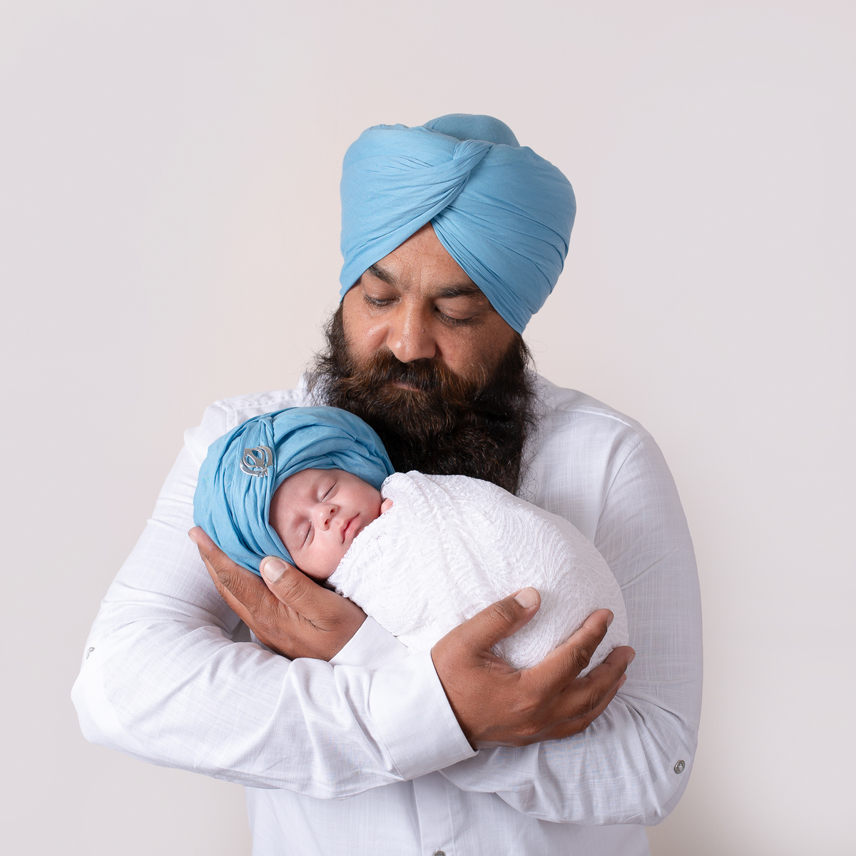 Sleeping newborn baby wrapped in neutral tones – professional newborn session in Vancouver