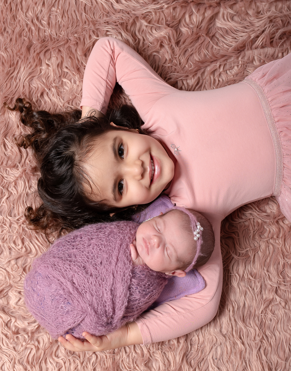 Newborn baby boy posed safely in father’s hands – Burnaby newborn photography studio