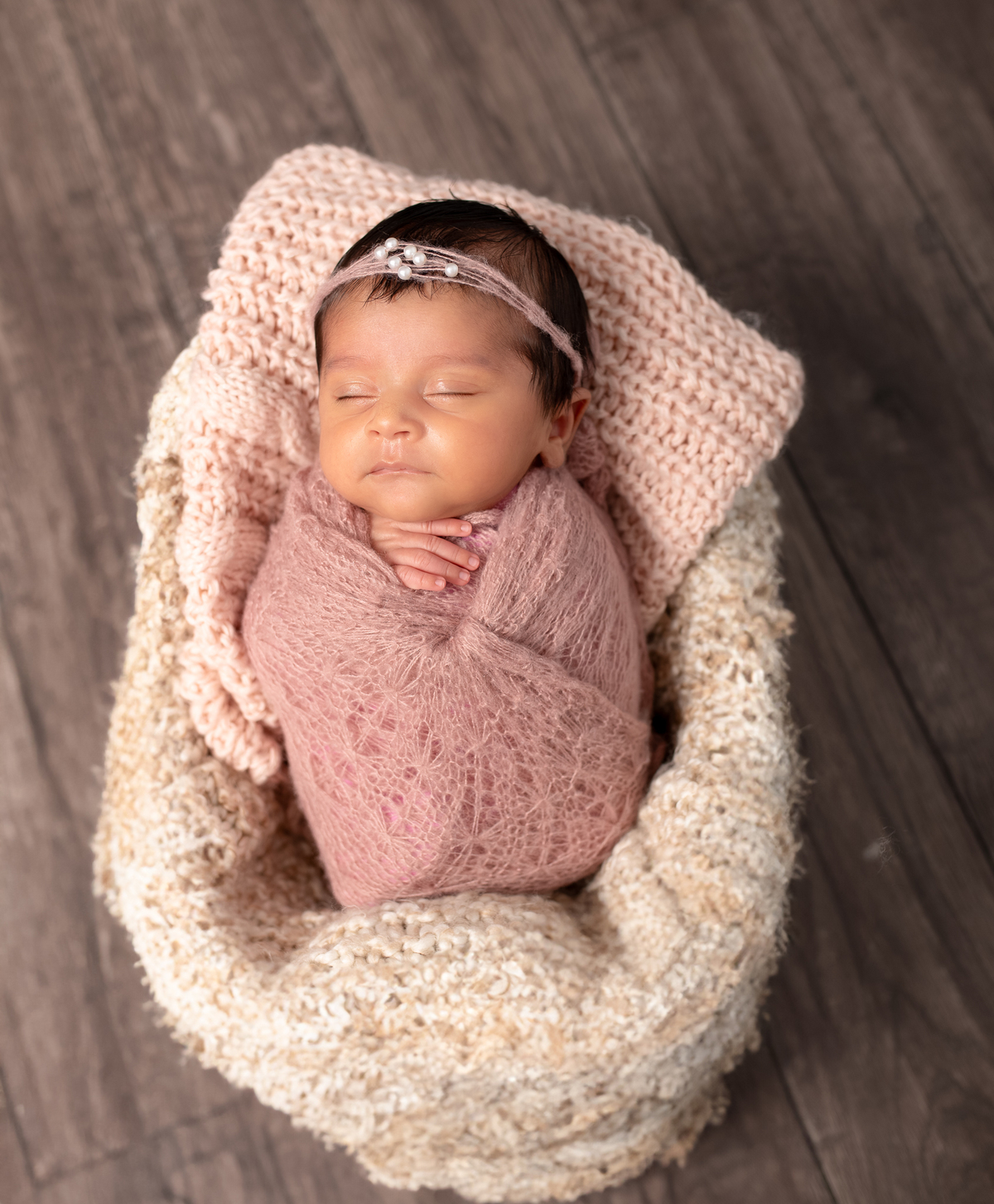 Newborn baby boy posed safely in father’s hands – Burnaby newborn photography studio