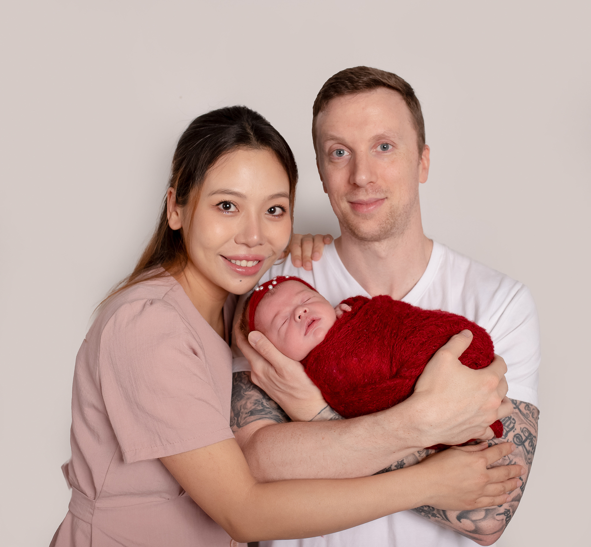 Newborn baby boy posed safely in father’s hands – Burnaby newborn photography studio
