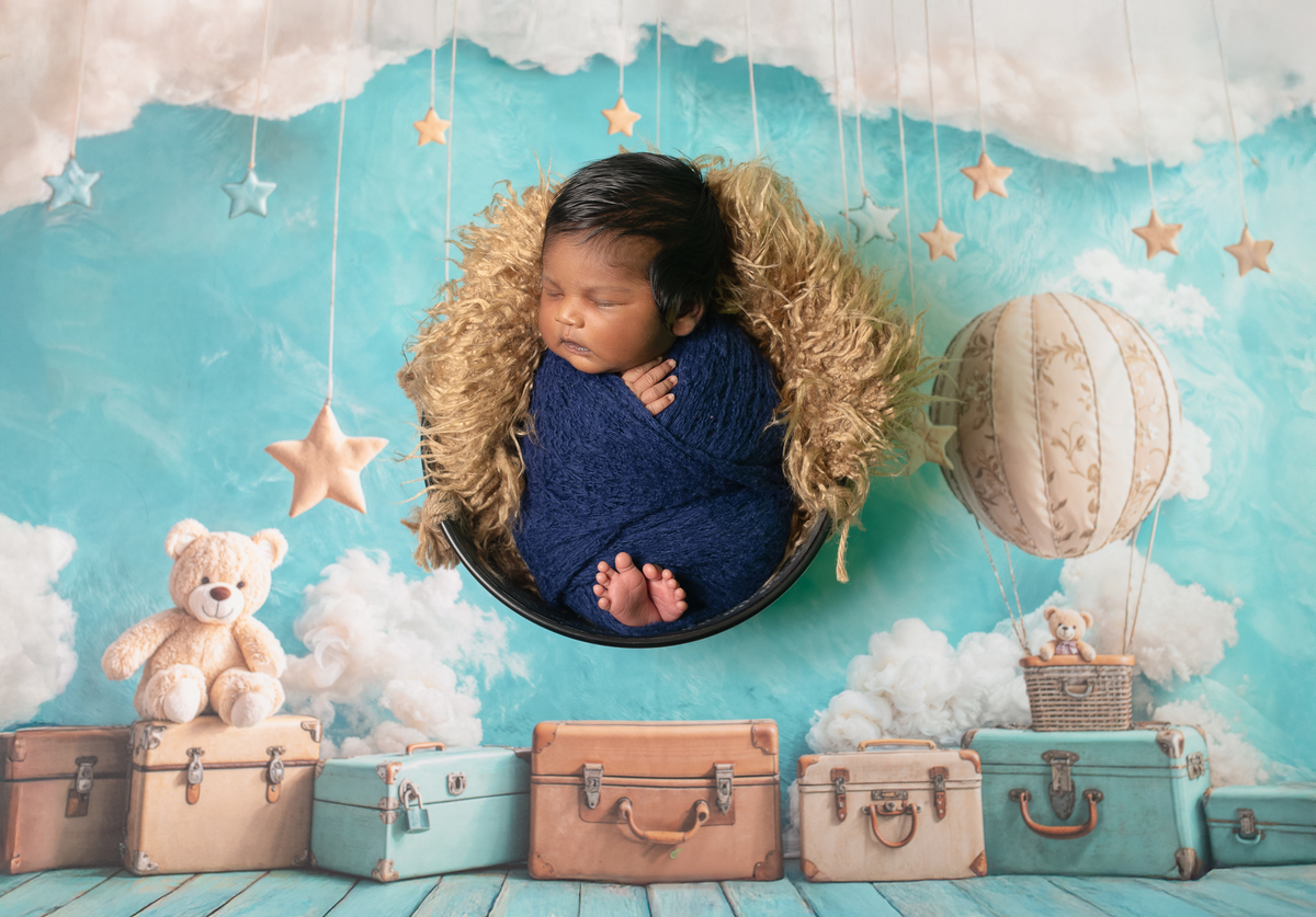 Newborn baby boy posed safely in father’s hands – Burnaby newborn photography studio