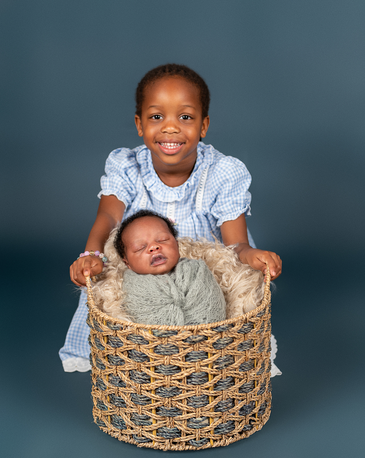 Newborn baby boy posed safely in father’s hands – Burnaby newborn photography studio