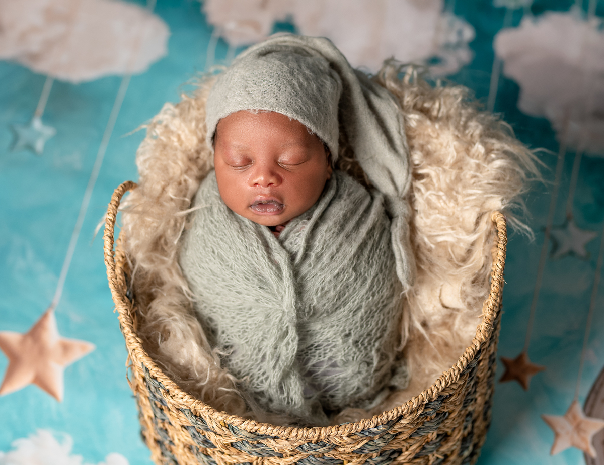 Newborn baby boy posed safely in father’s hands – Burnaby newborn photography studio
