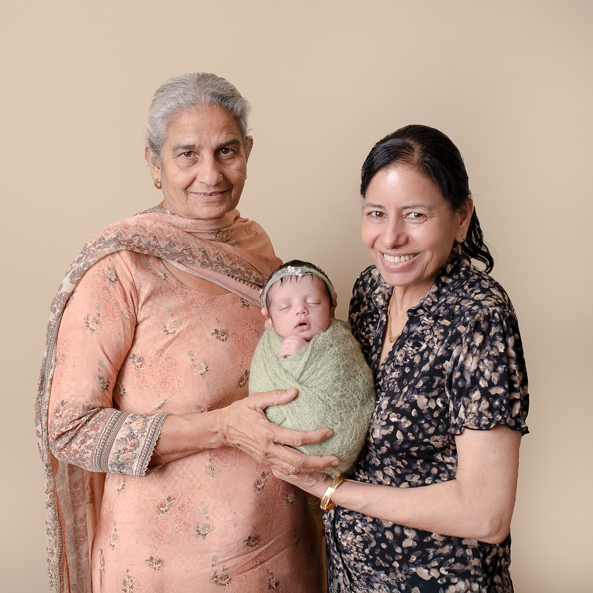 Sleeping newborn baby wrapped in neutral tones – professional newborn session in Vancouver