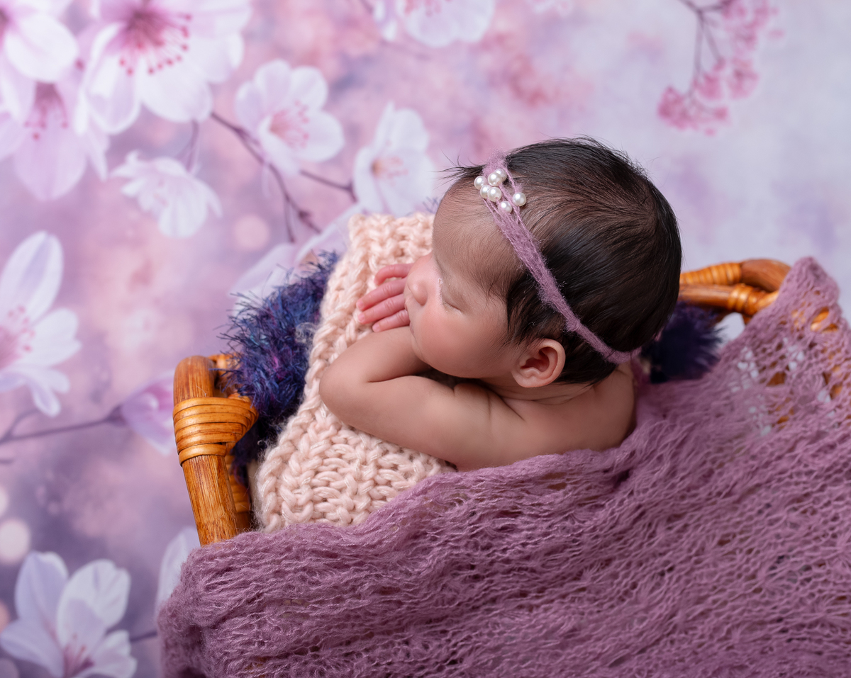 Sleeping newborn baby wrapped in neutral tones – professional newborn session in Vancouver