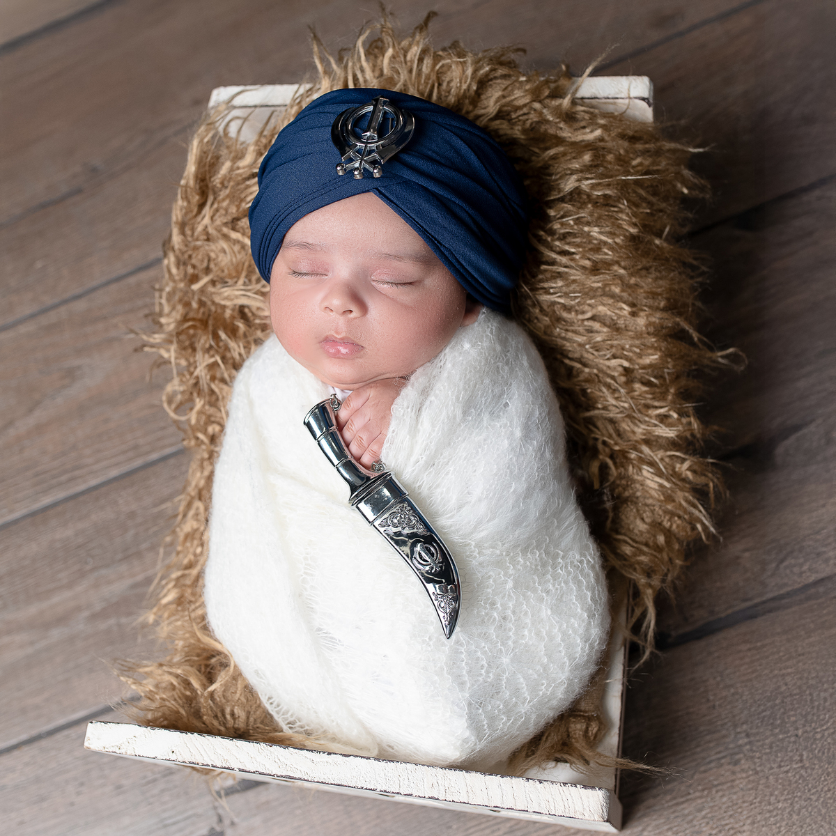 Newborn baby boy posed safely in father’s hands – Burnaby newborn photography studio