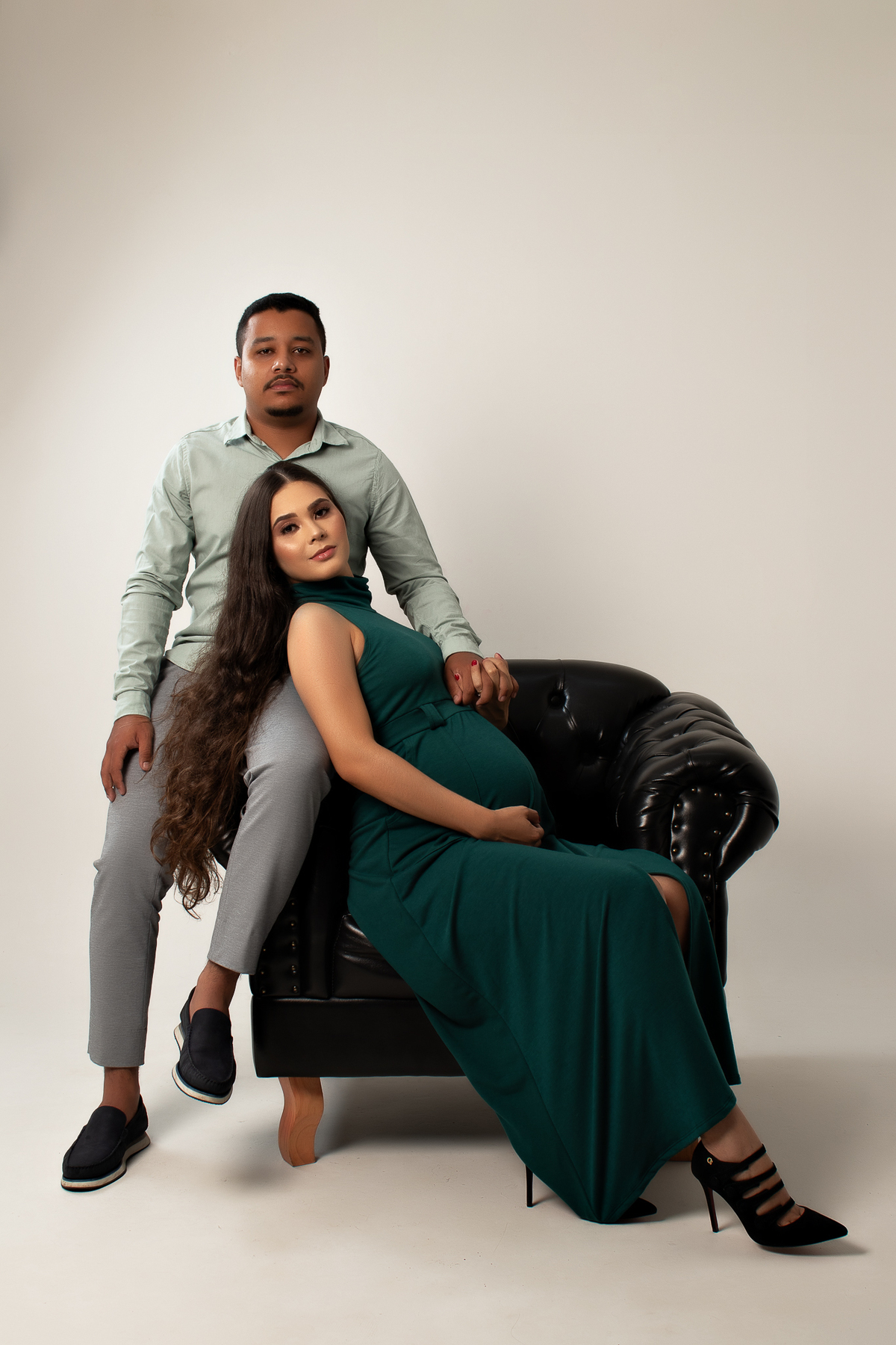 ensaio gestante em estúdio clean conceito vestido longo poltrona pose preto e branco com marido estúdio marcos felipe fotografia barreiro belo horizonte bh mg contagem ibirite