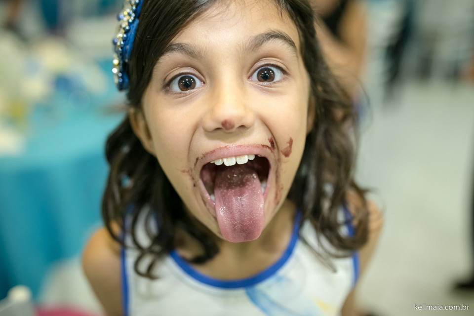 menina com boca suja de chocolate em aniversário infantil