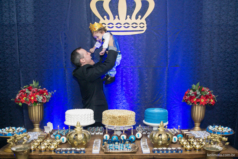 papai brincando com menino e três bolos no aniversário