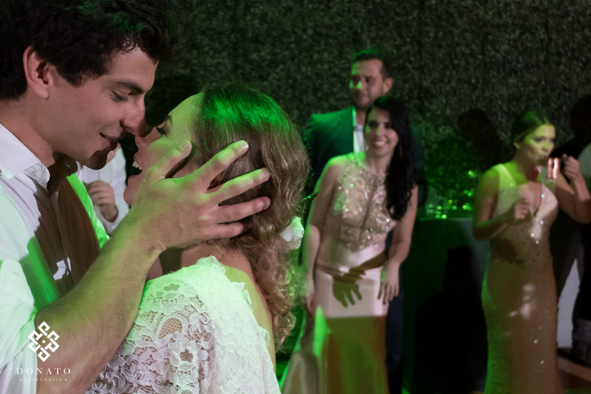 noivos se beijam na pista de dança.