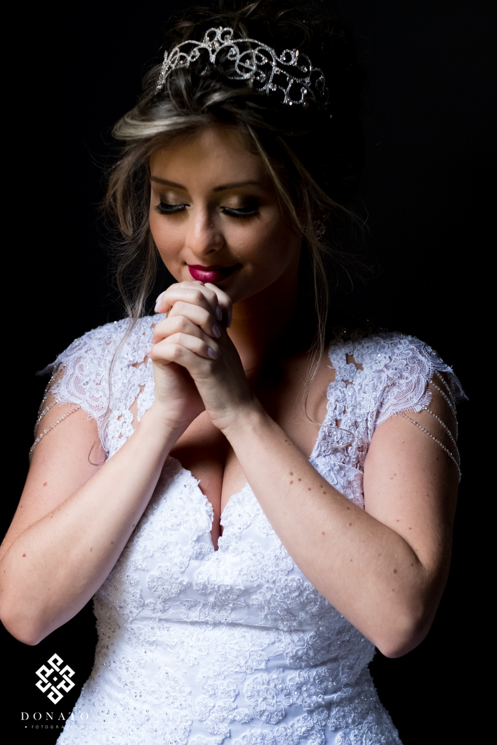 Noiva se concentra e reza antes da cerimonia, um lindo retrato da noiva com fundo preto.