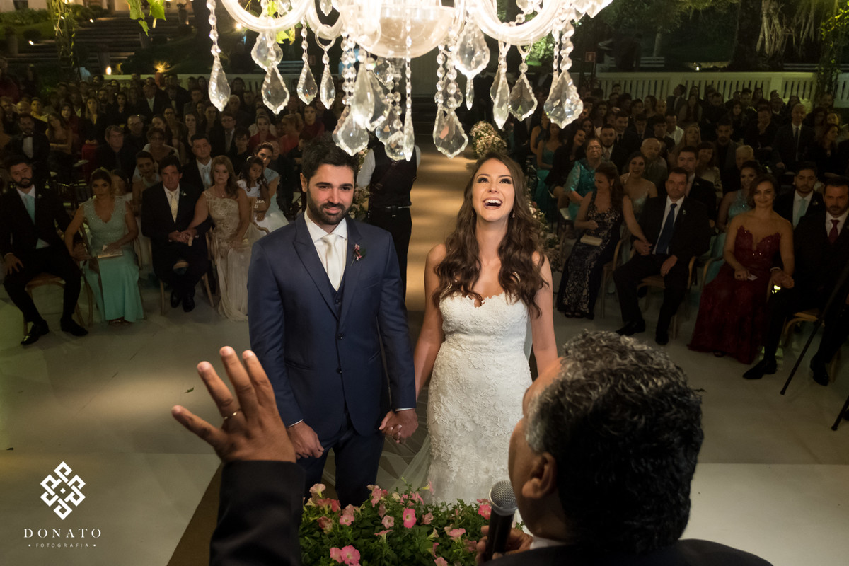 Noivos se divertem com o pastor.