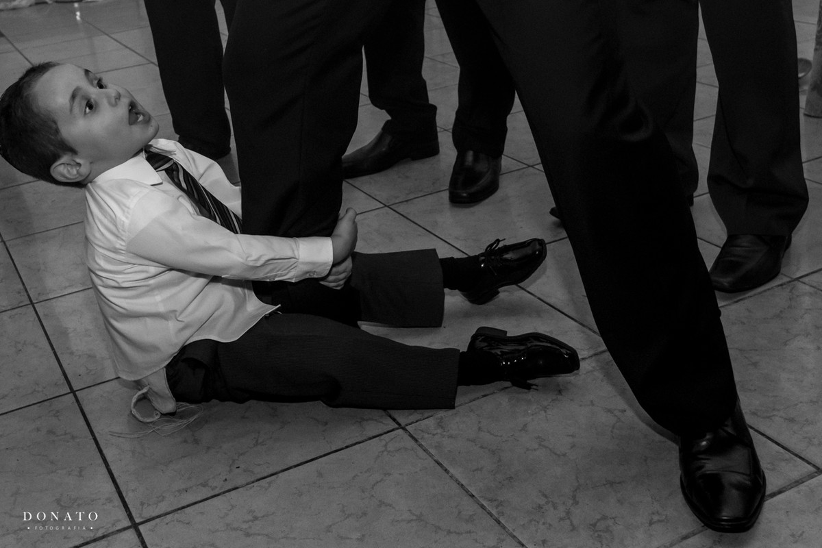 Pajem se agarra nos pés dos padrinhos, não querendo ir embora.