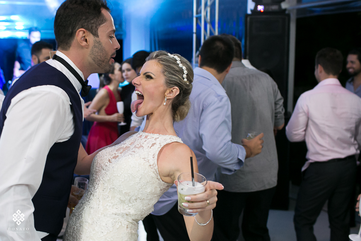 noiva mostra a língua enquanto dança com o noivo.