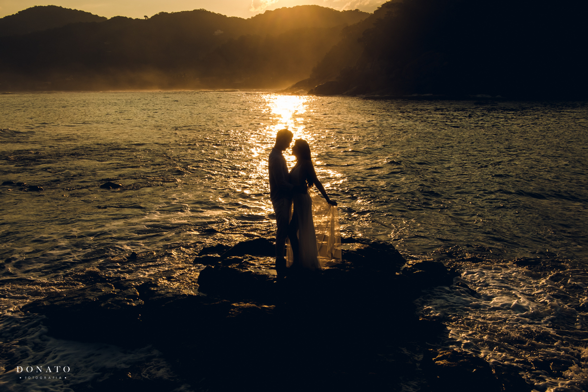 foto do casal na praia com por do sol, Guarujá sp.