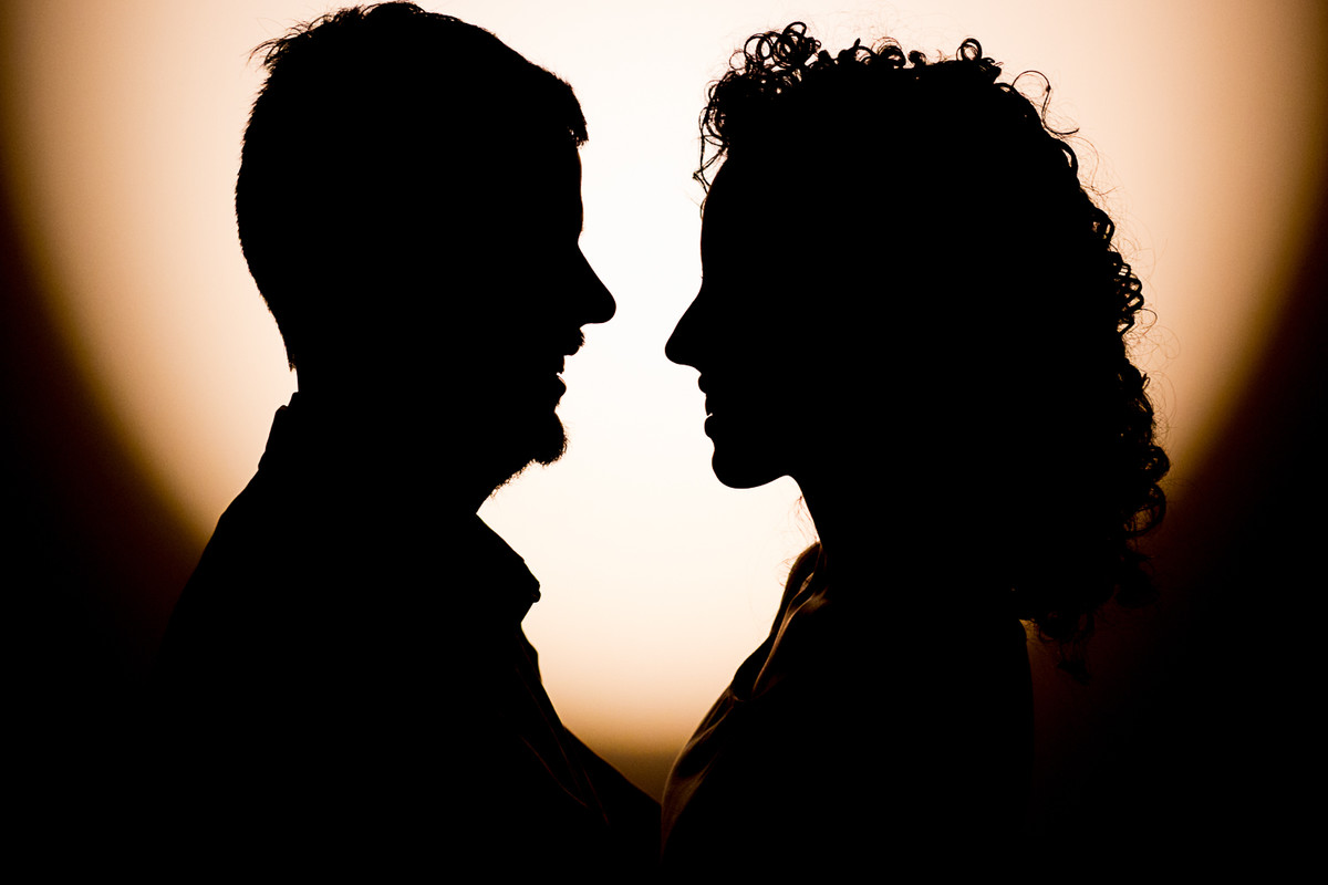 Silhueta do casal com um contorno com uma luz quente.