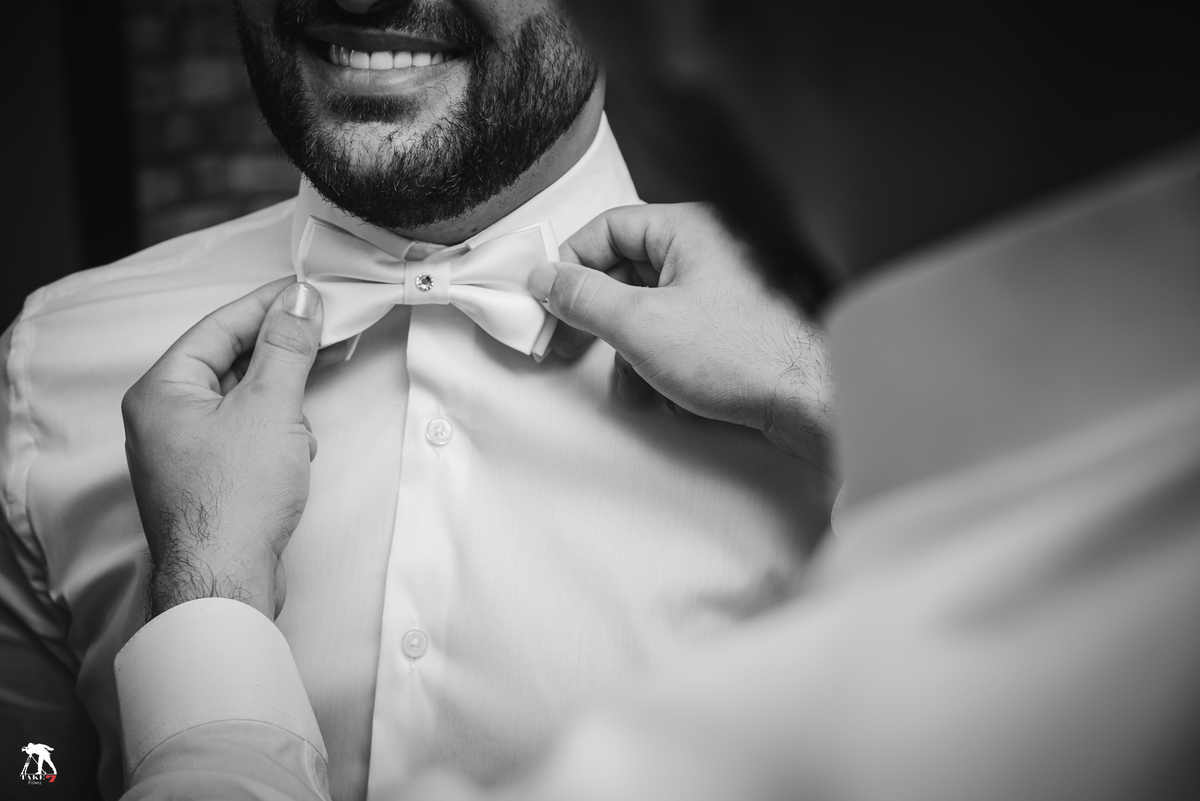 padrinho arrumando a grava do noivo