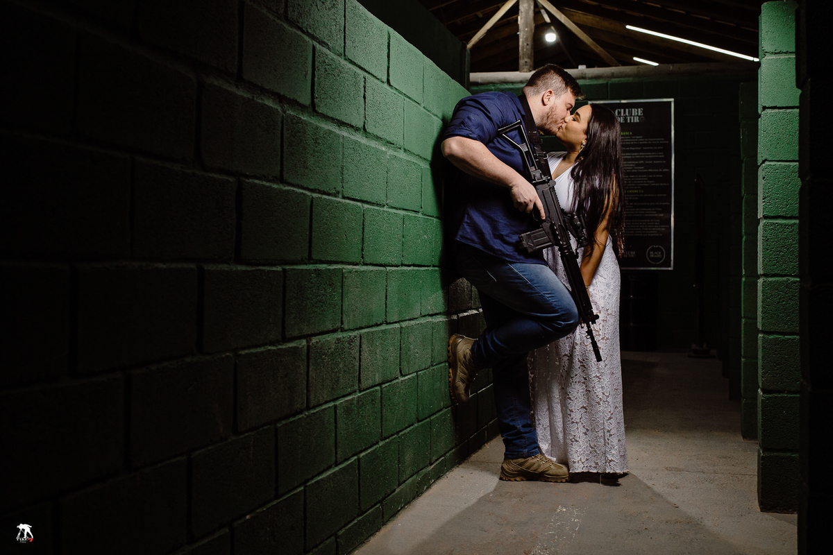 Noivos se beijando no clube de tiro 