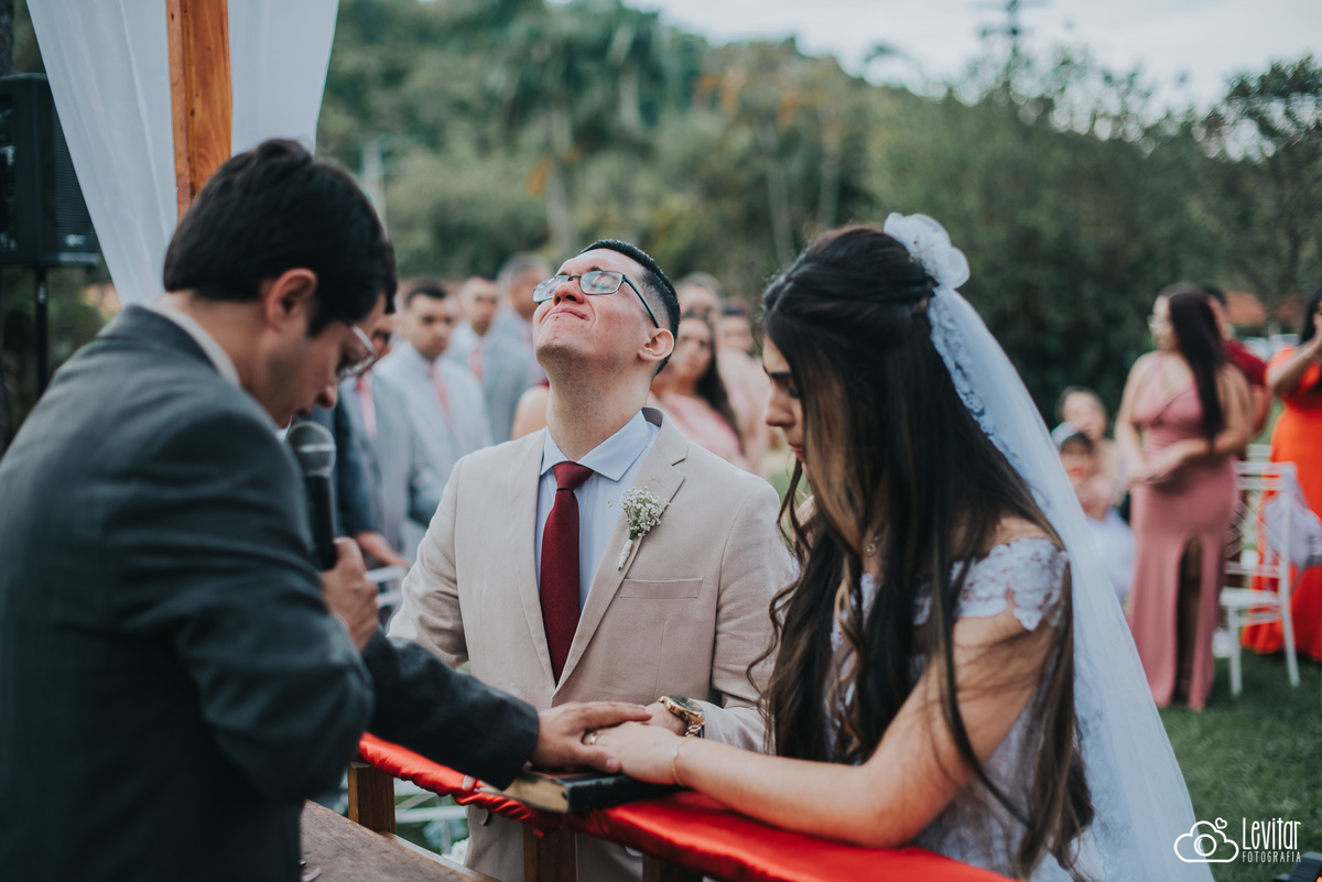 Noivos e pastos com a mão na bíblia