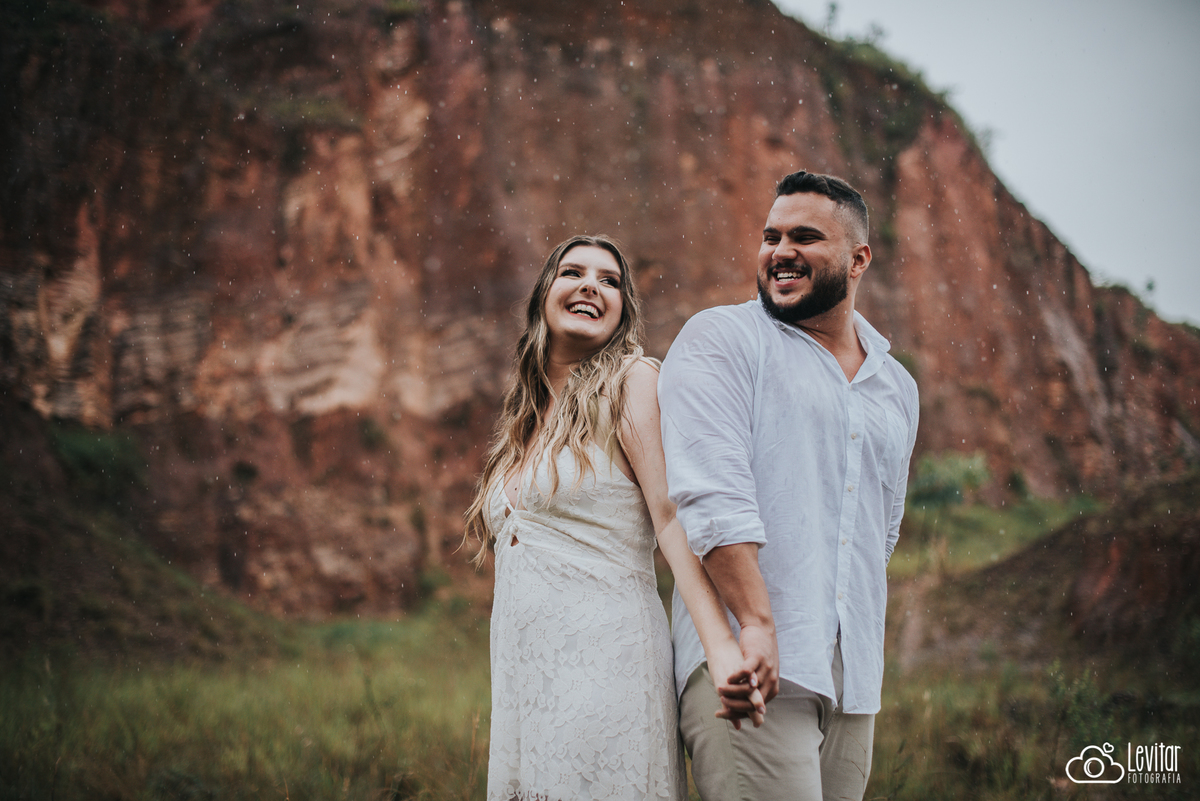 casal sorrindo na chuva