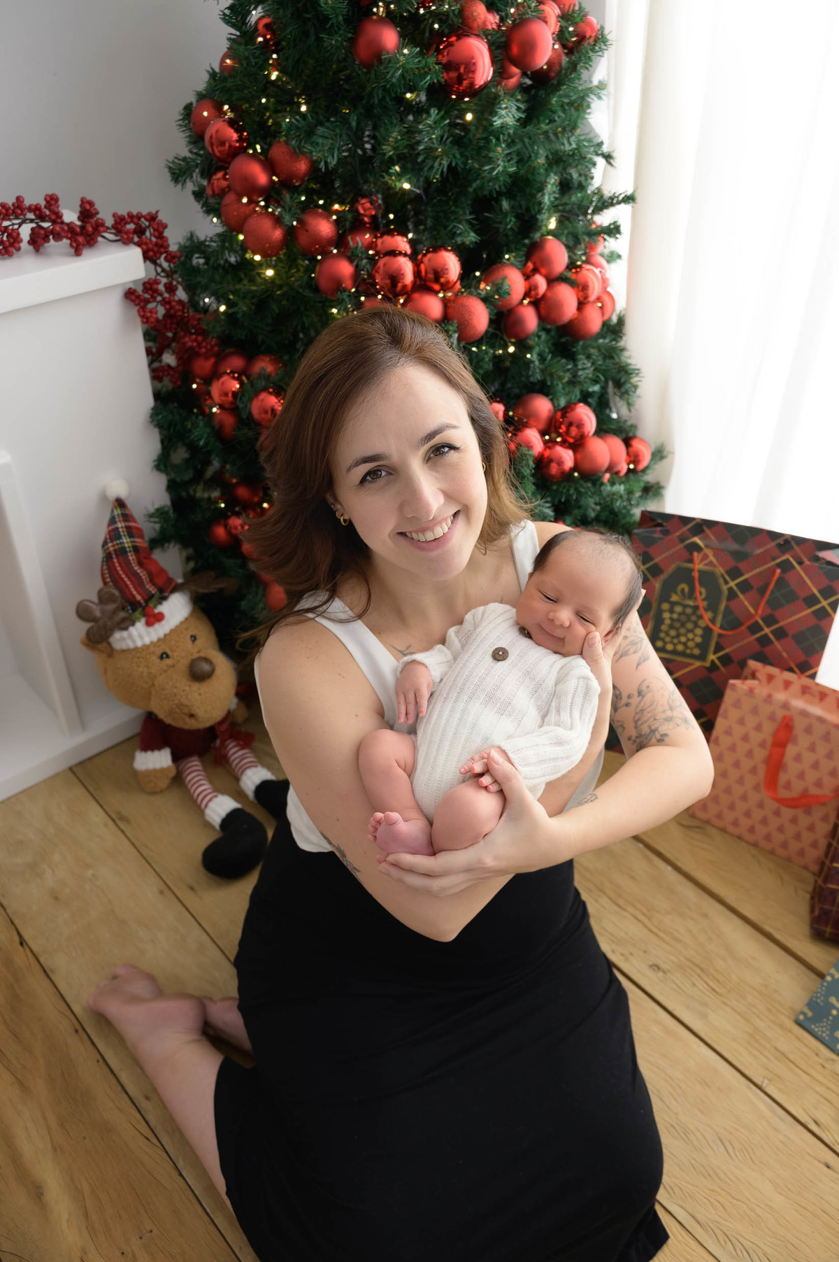 mamãe segurando o filho na sessão de fotos newborn realizada em estúdio especializado em fotografia newborn em São Paulo/SP