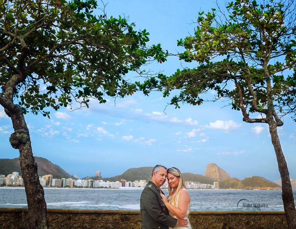 fotos ensaio pre casamento rj, casal de cabeça encostada na mureta do forte de copacabana por andré nogueira fotografia