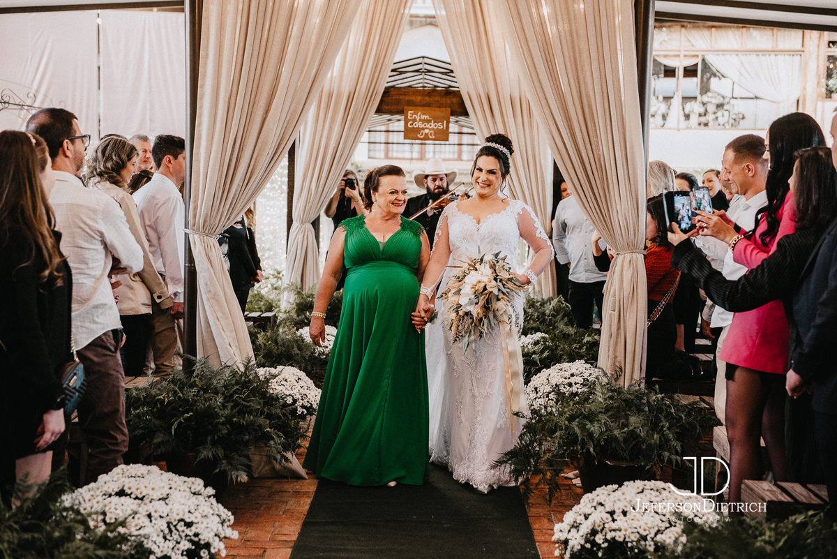 noiva entrando no casamento com a mae