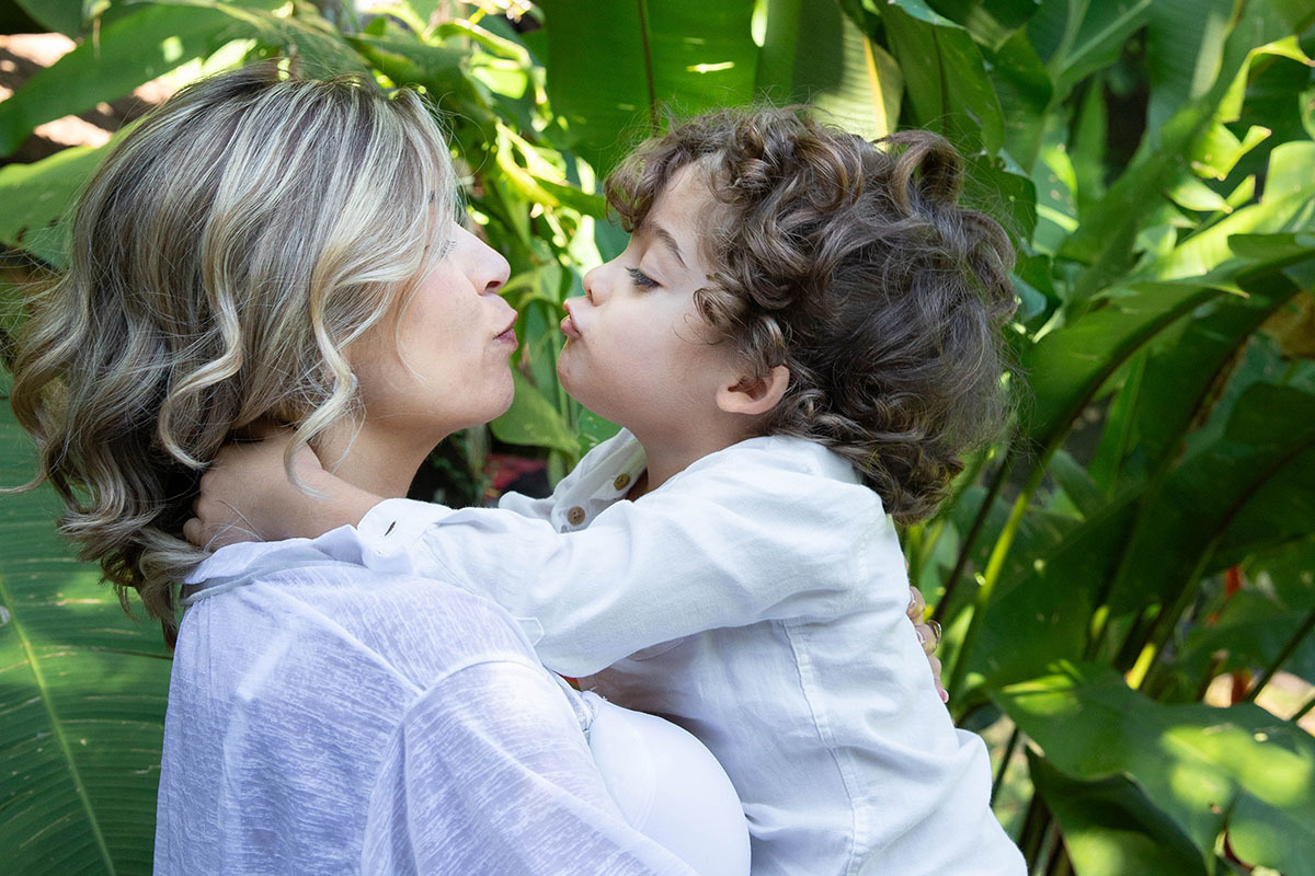 Ensaio de gestante: Isabela beijando o Caio no jardim - Rio de Janeiro.