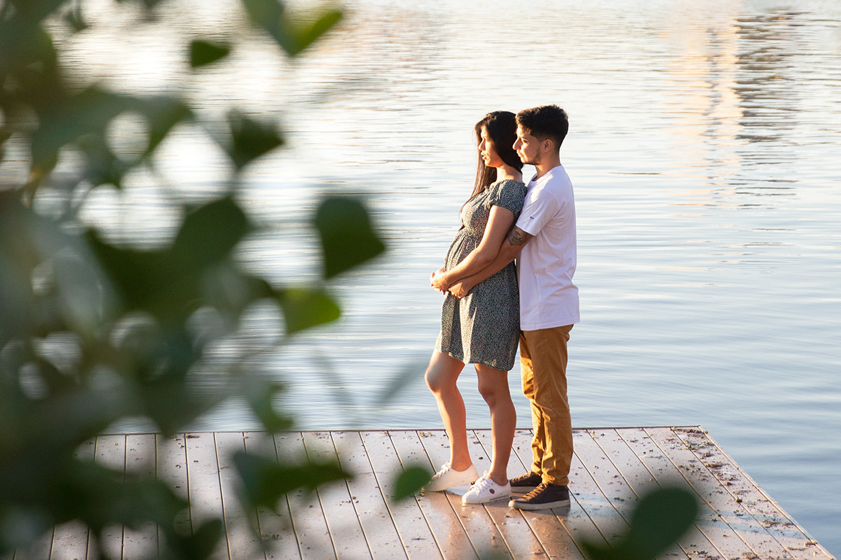 Gestante em ensaio na Lagoa RJ cercada pela natureza verde.