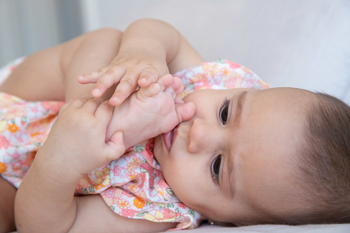 Ensaio de bebê: Marina com o pé na boca, no Rio de Janeiro.