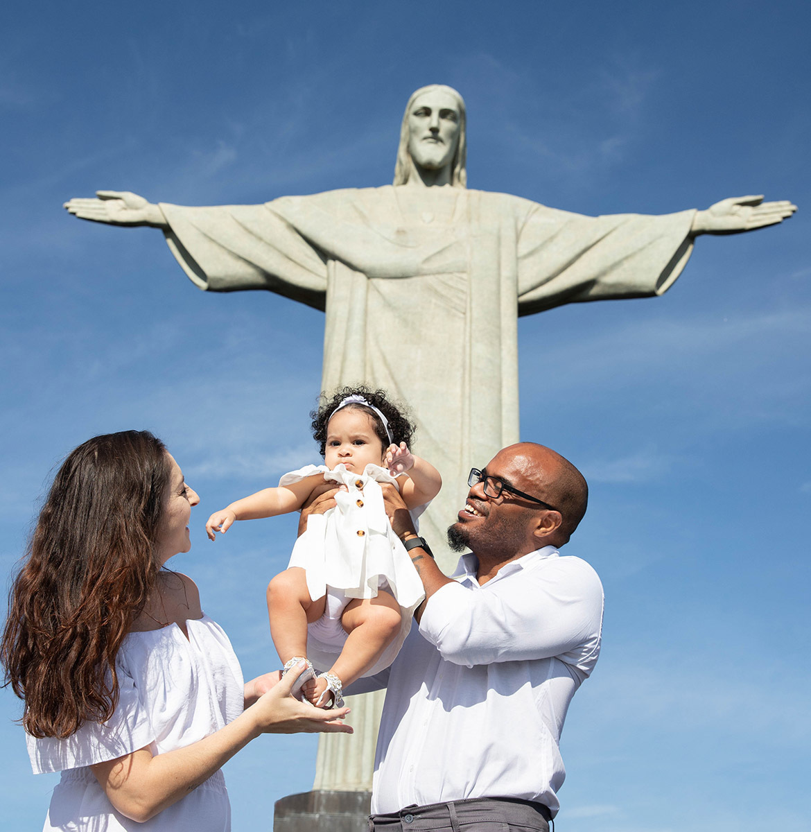 Batizado da Maria Ceília: Larissa e Estevam em frente ao Cristo Redentor no Corcovado, no Rio de Janeiro.