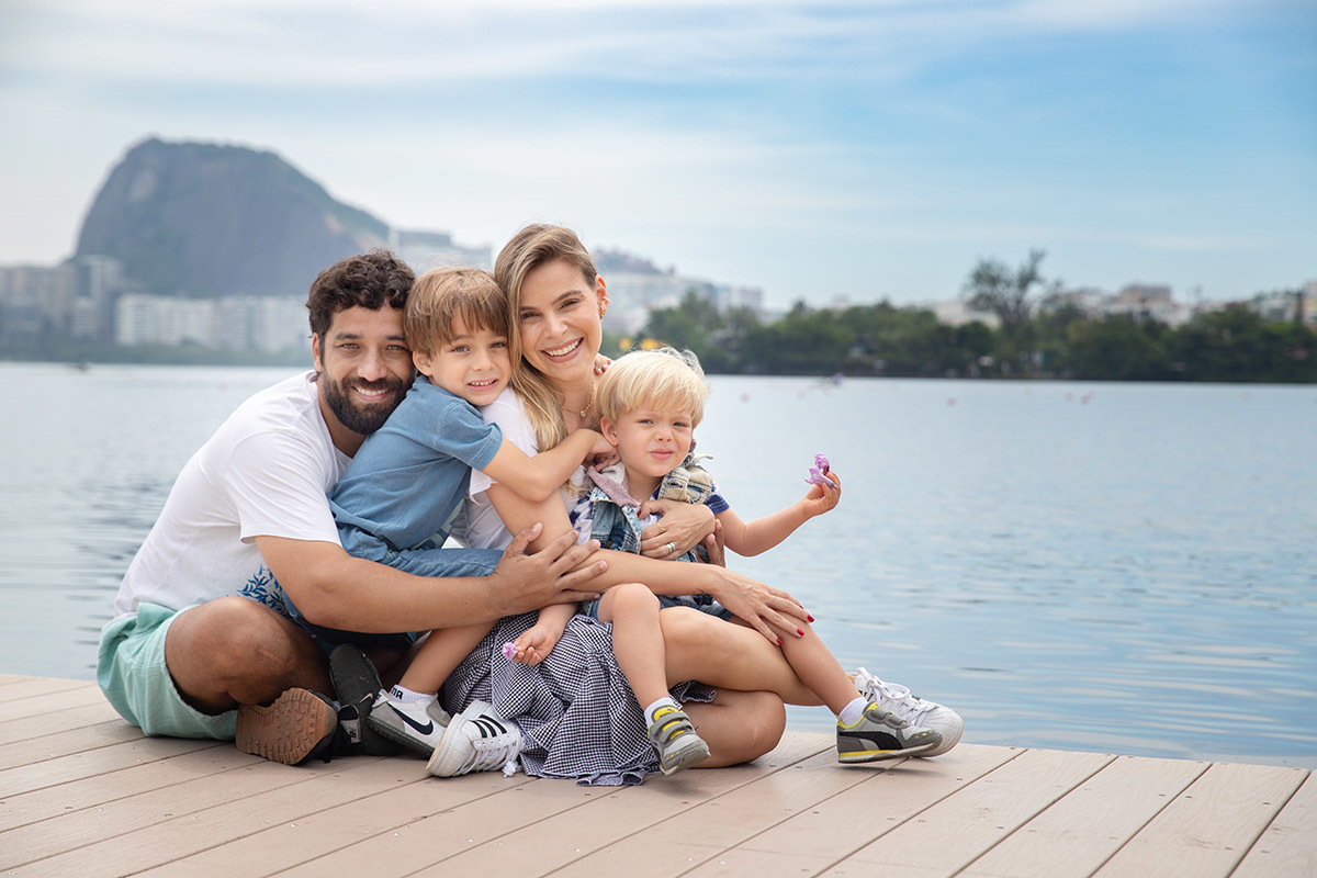 Ensaio de família na Lagoa Rodrigo de Freitas com pais e filhos em momento de carinho
