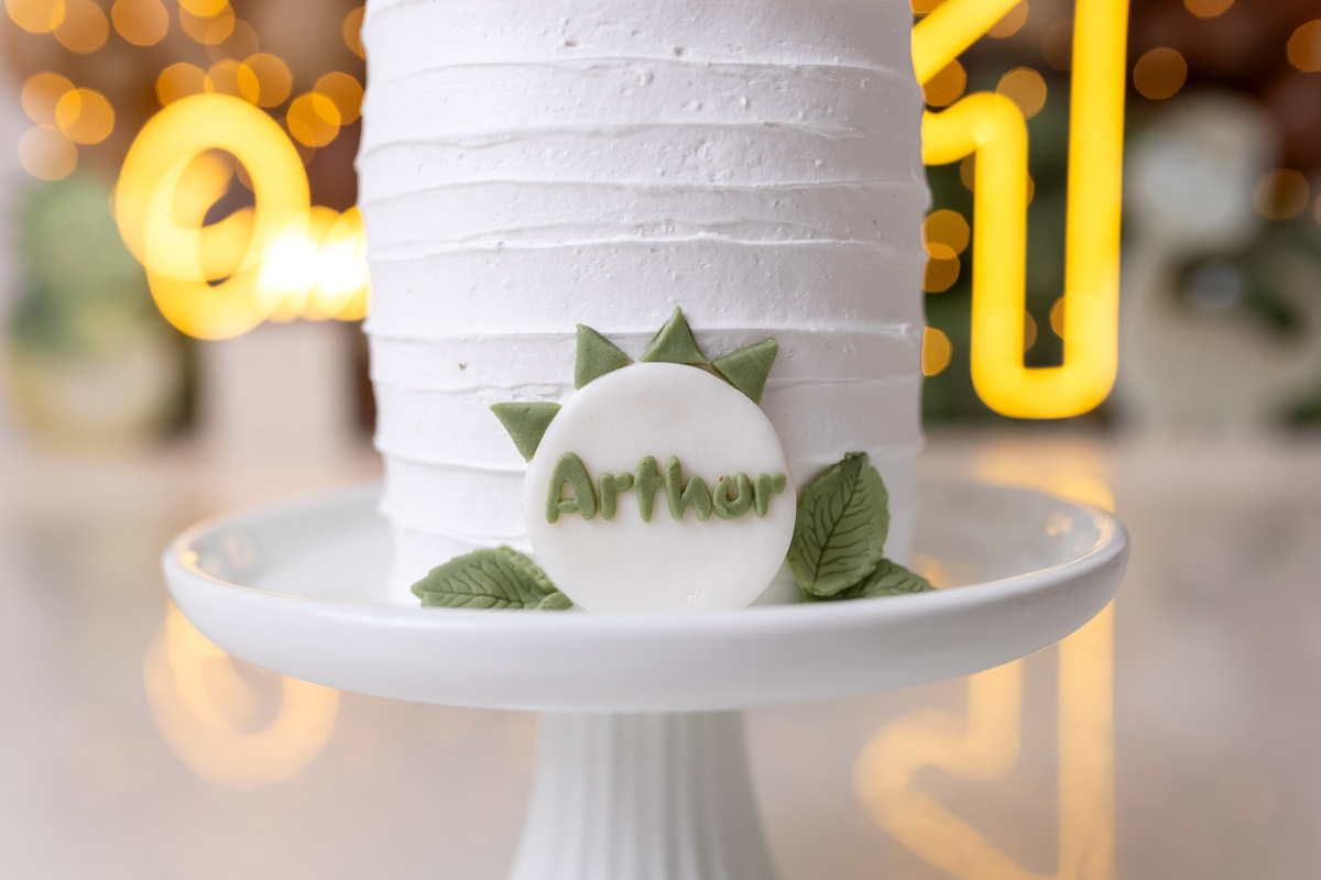 Bebê Arthur sorrindo no ensaio smash the cake tema baby dinossauro no estúdio On Click Fotografia em Caraguatatuba