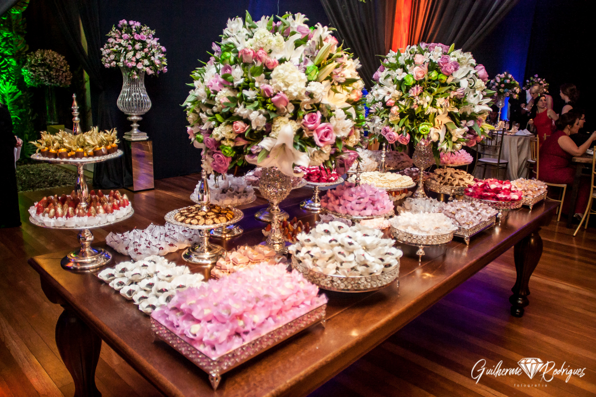 Mesa dos doces decorada com flores para o casamento