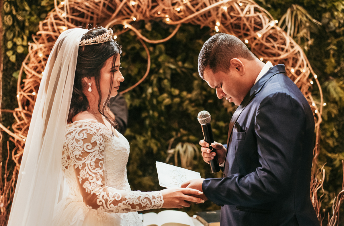 Fotografia dos noivos no altar, hora dos votos, em cerimônia de casamento de Mariana e Matheus realizada na Casa de Festas Espaço Kieza, em Nova Iguaçu, RJ