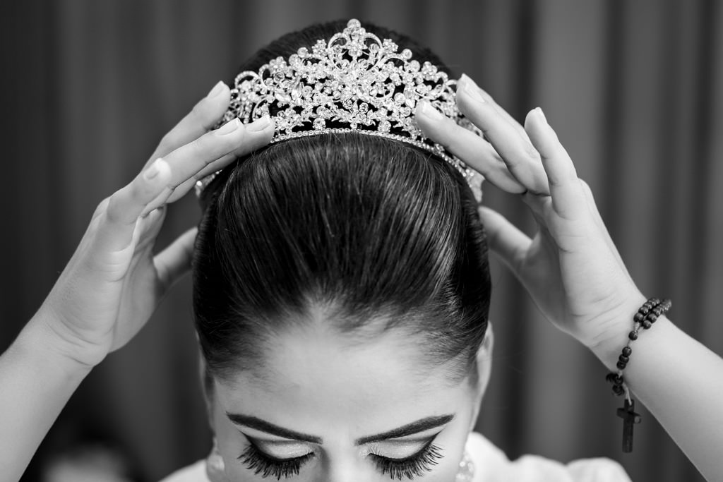 a noiva Nayara durante o making of colocando a tiara, no salão Marcos Soares