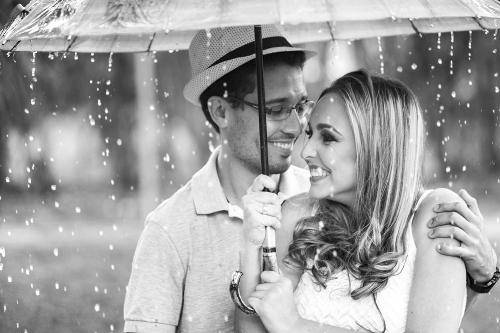 Escondendo debaixo da sobrinha colorida sob a chuva o sorriso e olhares de driely e william