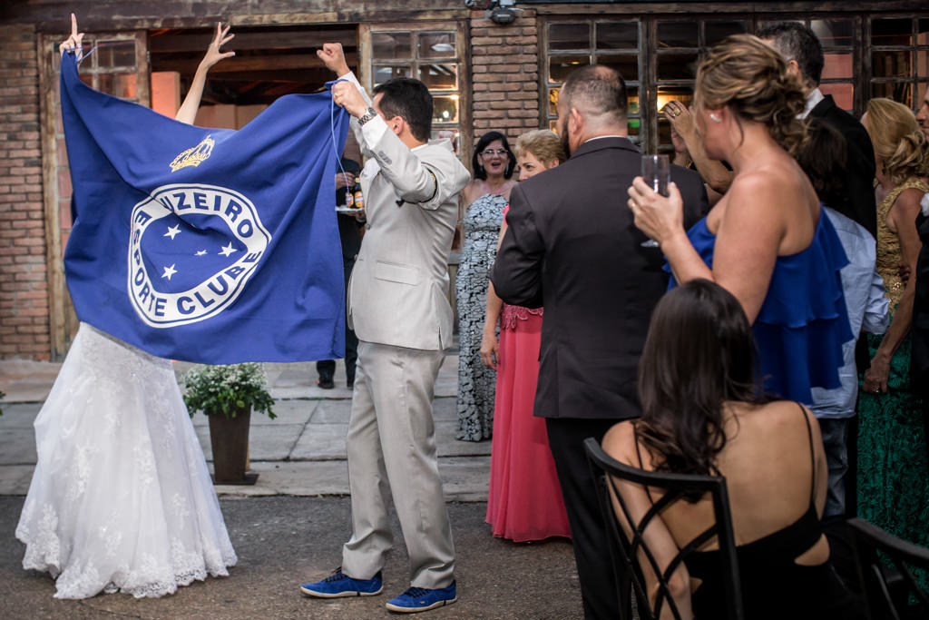 depois da cerimônia a saída triunfal dos recém casadas segurando a bandeira do cruzeiro e cantando o hino
