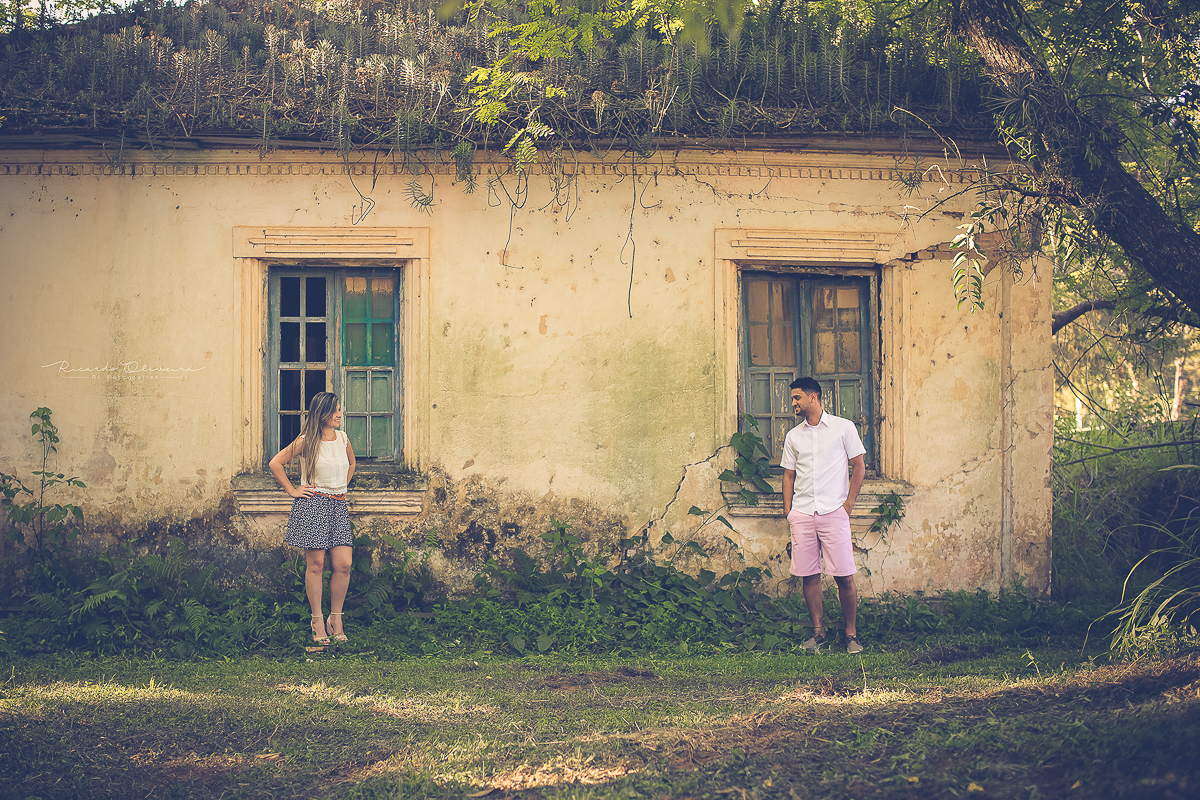 Casal posando em frente casa velha