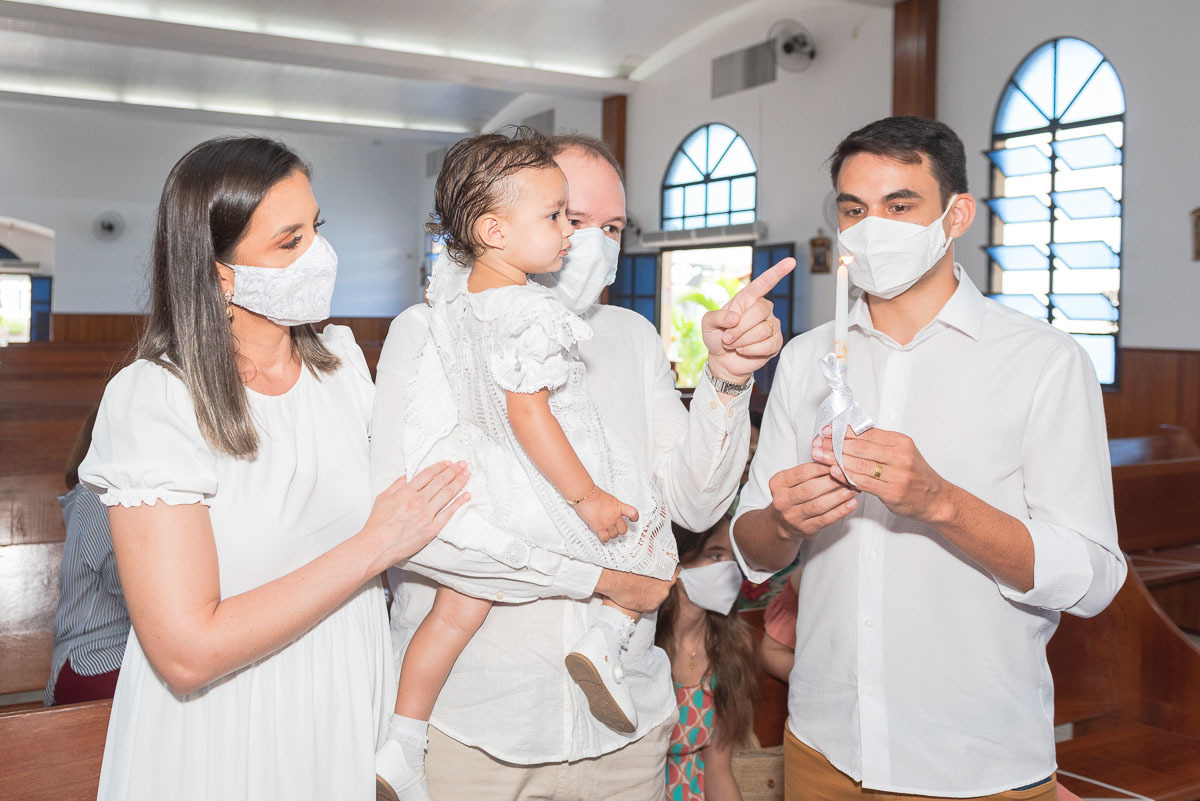 pai mostrando a vela do batismo