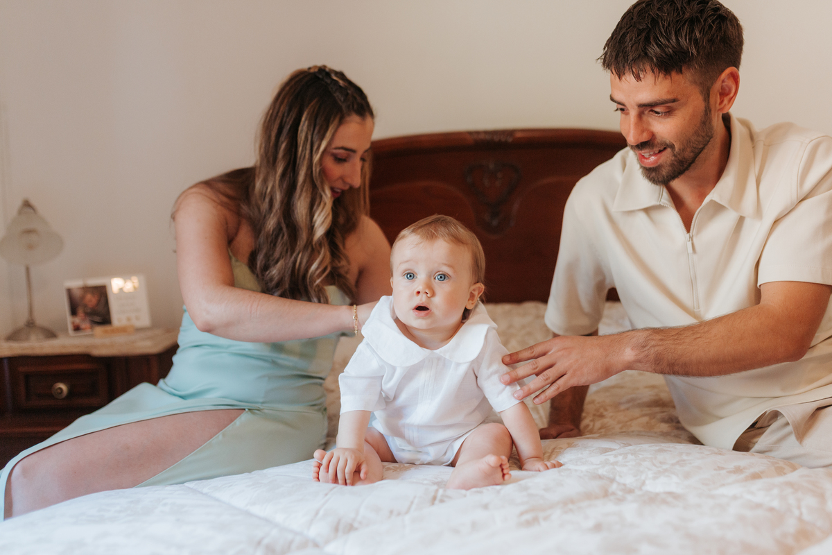 Registo fotográfico profissional de família cheia de afeto e conexão no batizado.