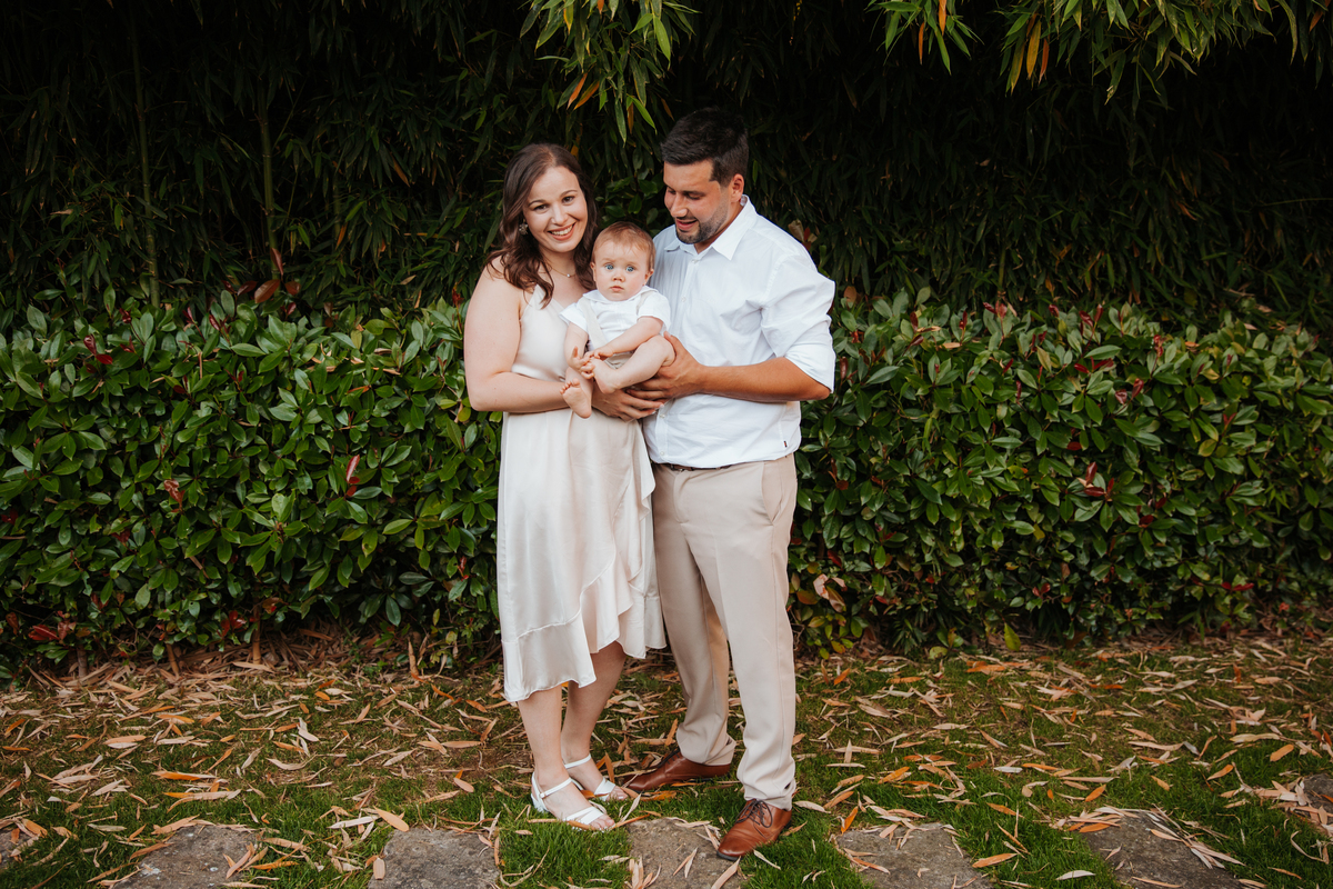Registo fotográfico profissional de família cheia de afeto e conexão no batizado.