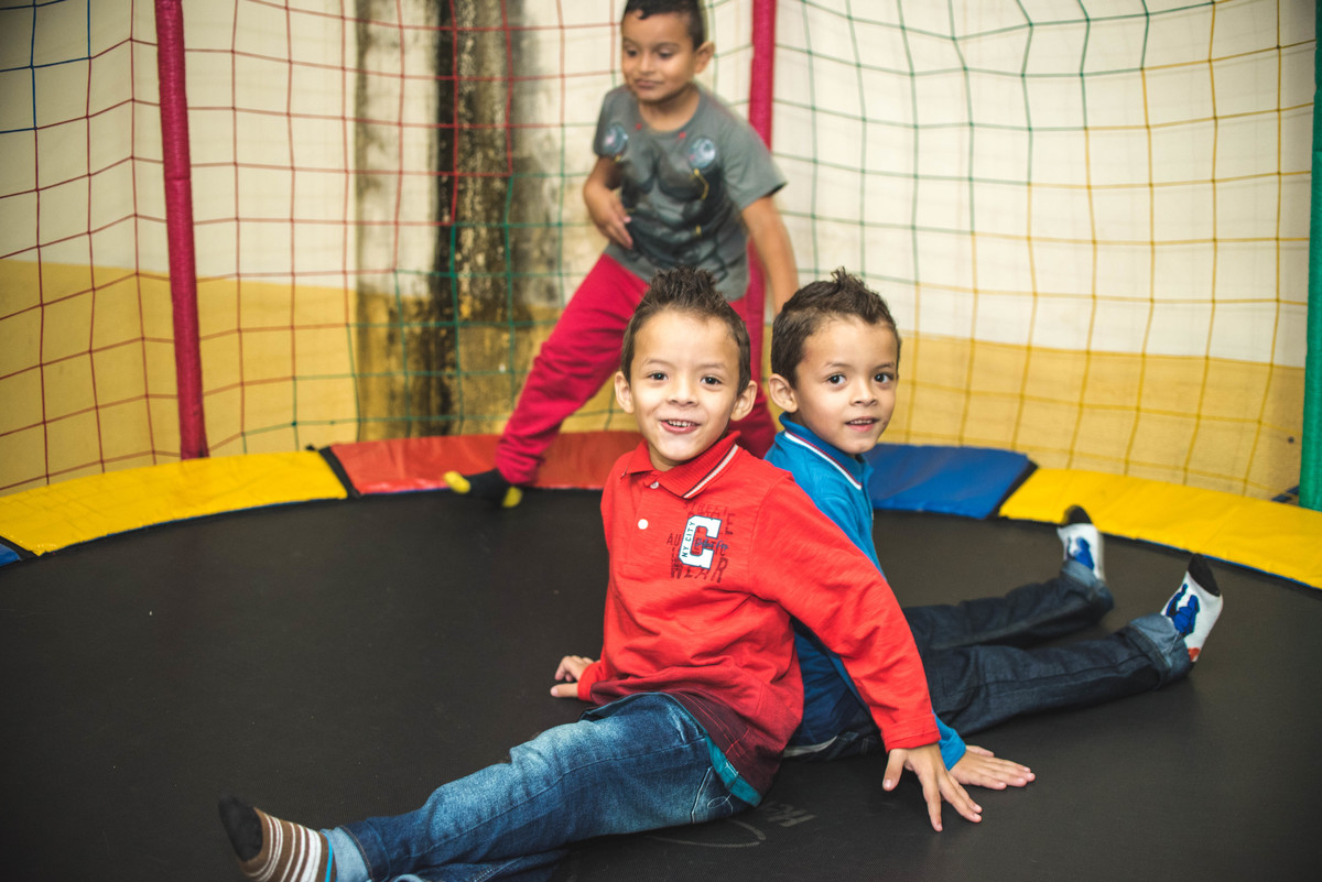 Primos brincando na cama elástica