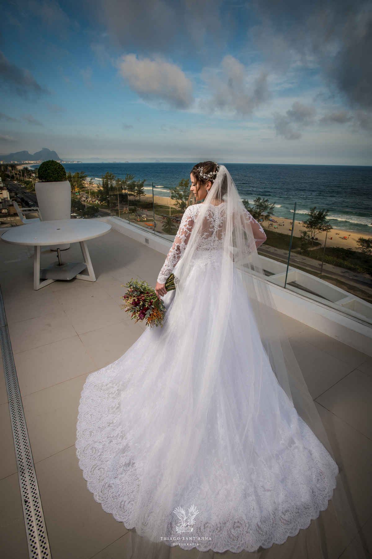 Noiva na sacada vestido buquê véu 