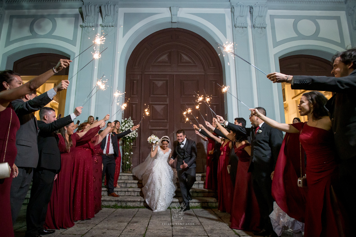 Saída dos noivos com sparkles na porta da igreja