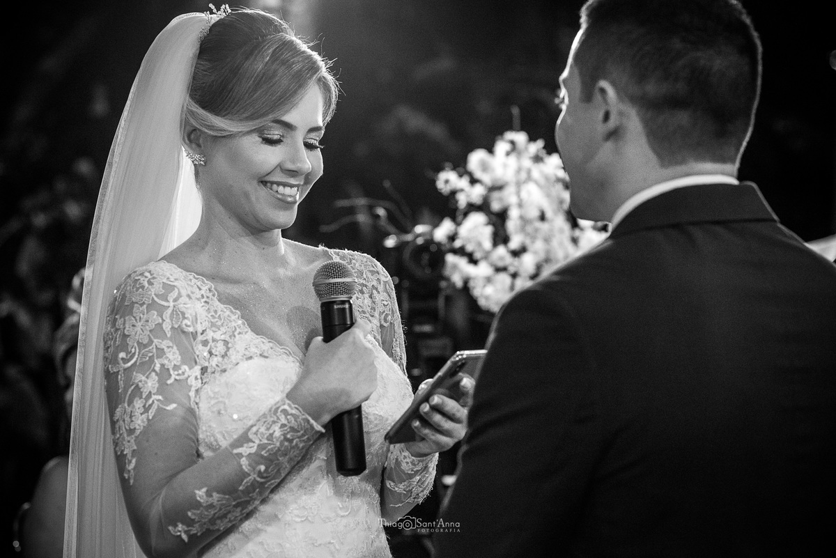 noiva sorri lendo seus votos preto e branco