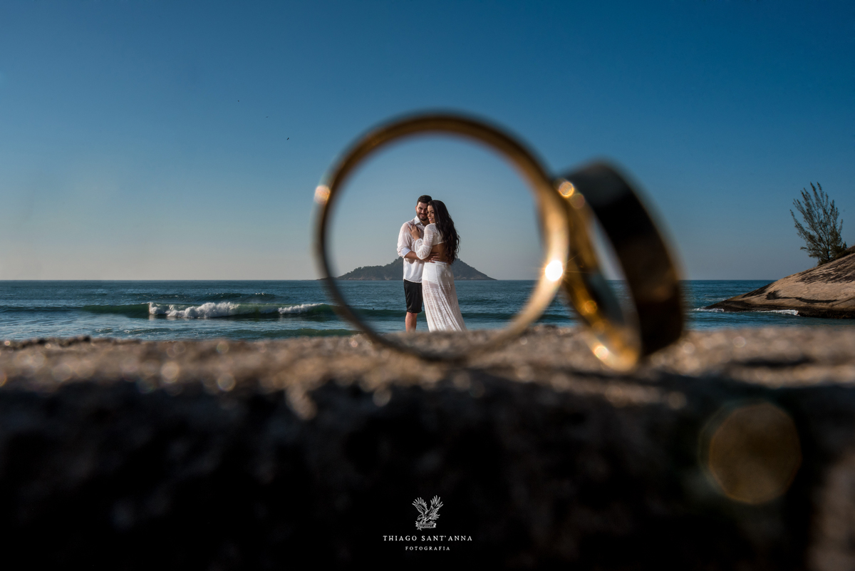 ensaio casal através das alianças paisagem praia por do sol 