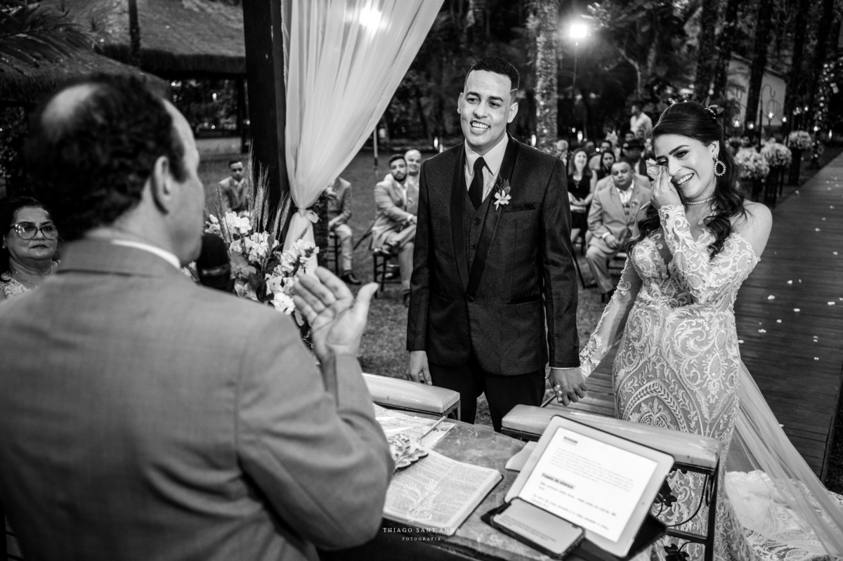 noivos no altar noiva emocionada enxuga as lágrimas preto e branco